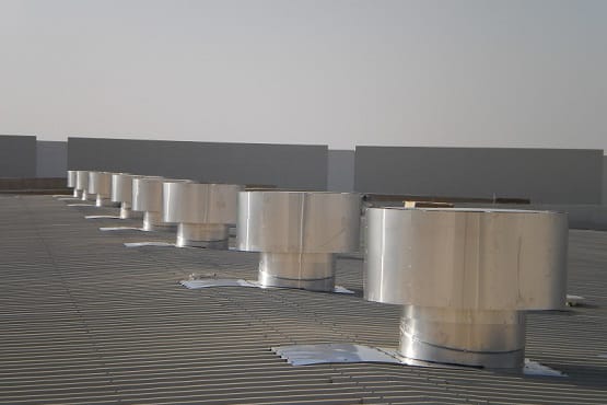 Hurricane Plus static wind induced ventilator on the roof of an industrial building arranged in a single line of 8