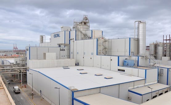 Large white an blue industrial complex with OCTAL logo on the side using natural ventilation system